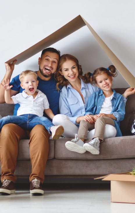 happy family mother father and children move to a new apartment and unpack boxes